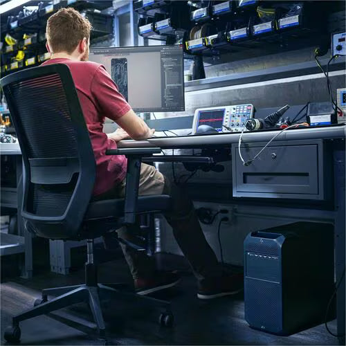 HP desktop tower on the floor beside monitors in a server workspace