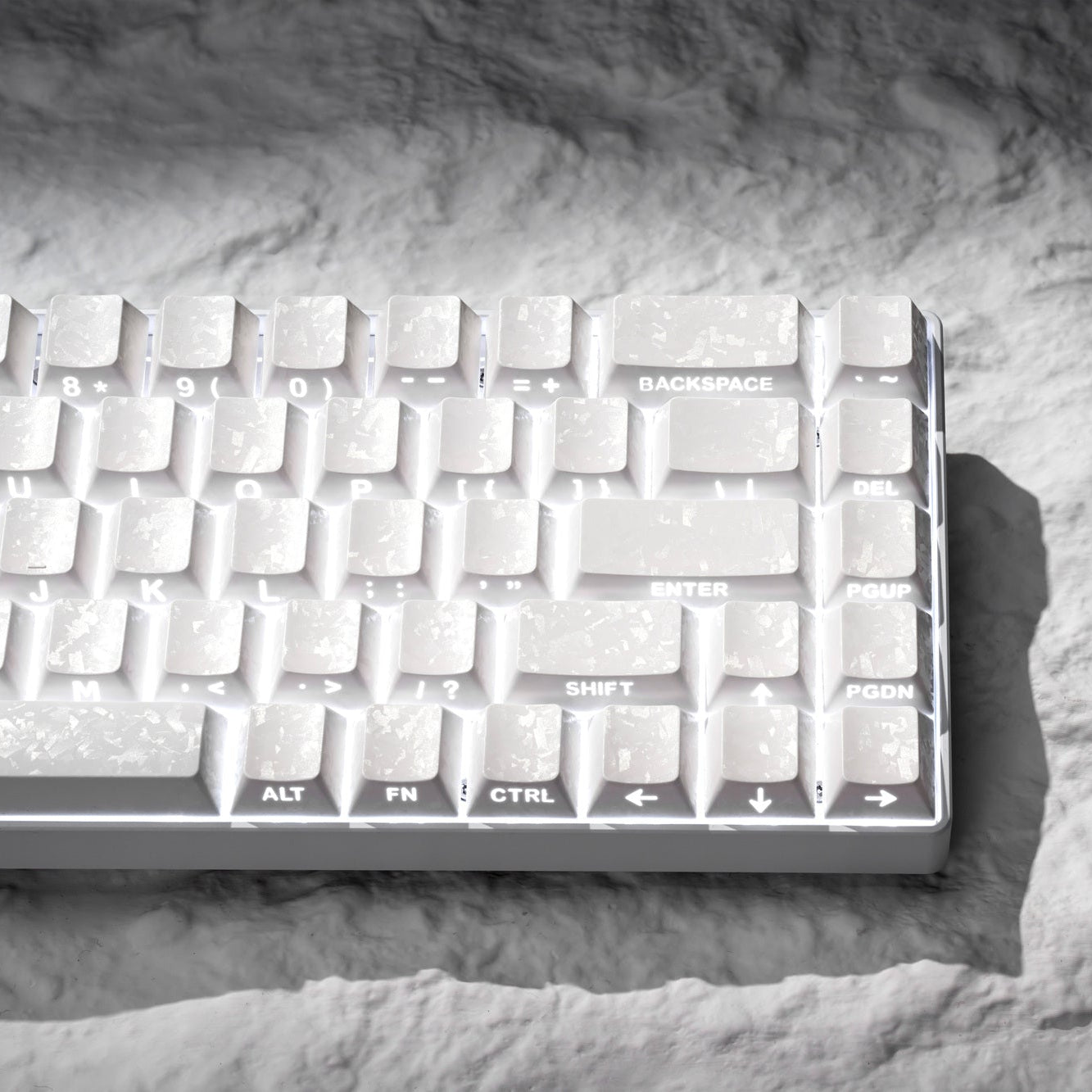 White cherry-profile PC keycaps with side-printed legends, top view on gray foam