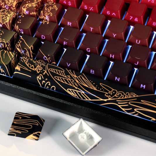 Dark maroon keycaps with gold wave side graphics and illuminated legend letters