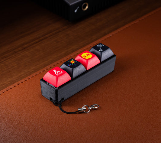 Atari Keycap Fidget with red keycaps and metal keychain clasp attached