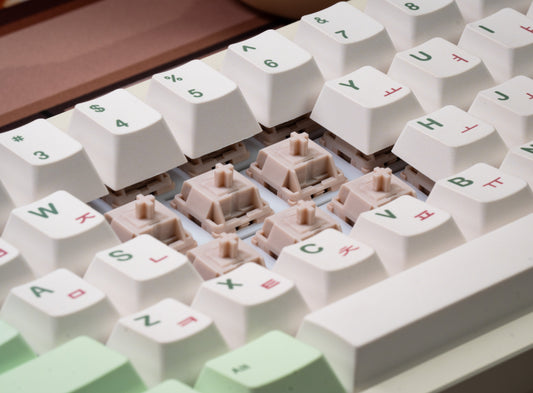 Cream mechanical switches with white keycaps around the key sockets