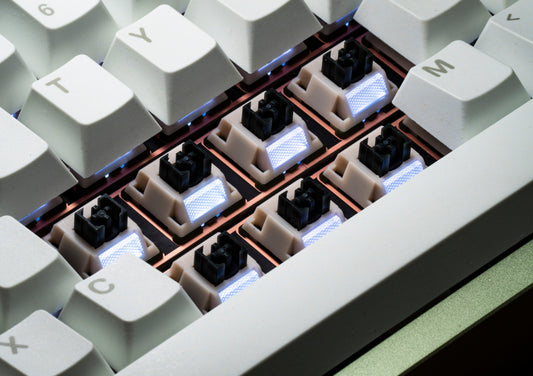Set of tactile keyboard switches installed in a plate, with illuminated light diffusers