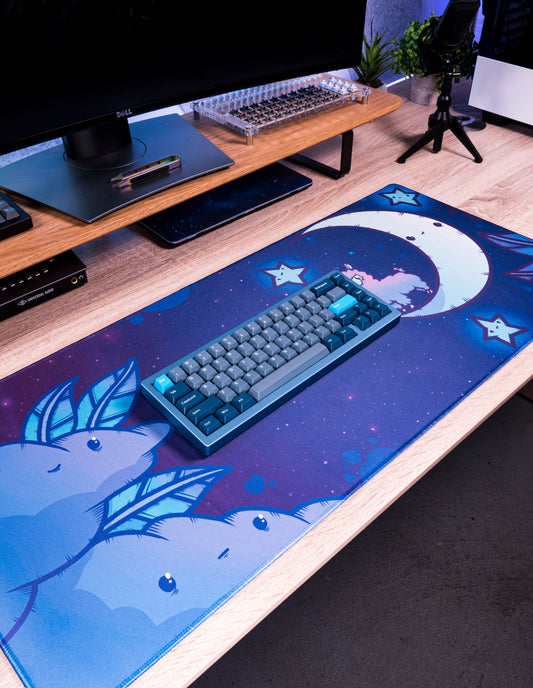 Blue desk mat with alpaca moon stars; keyboard and mouse resting on it