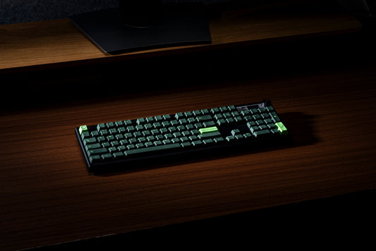 Green and black PBT keycaps with “Hello World” on a compact keyboard layout