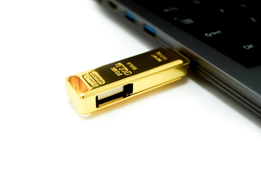 Gold USB flash drive with exposed USB-A end and blue port marking detail.