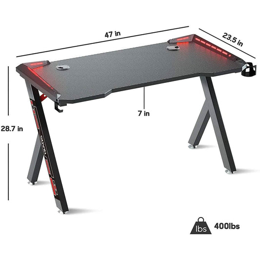 Gaming desk with black top, red LED strips, sturdy metal legs; size indicators shown