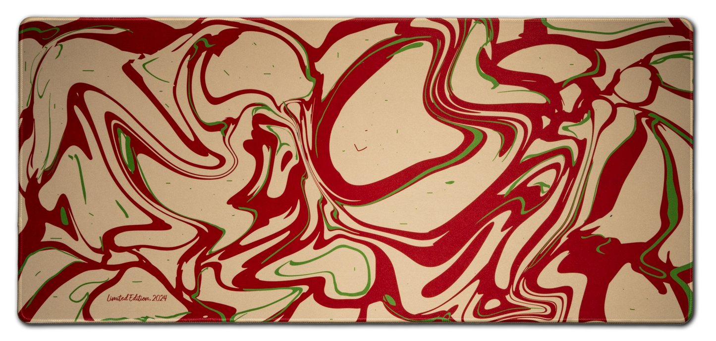 Desk mat with red, cream, and green liquid marble swirl pattern and rounded corners