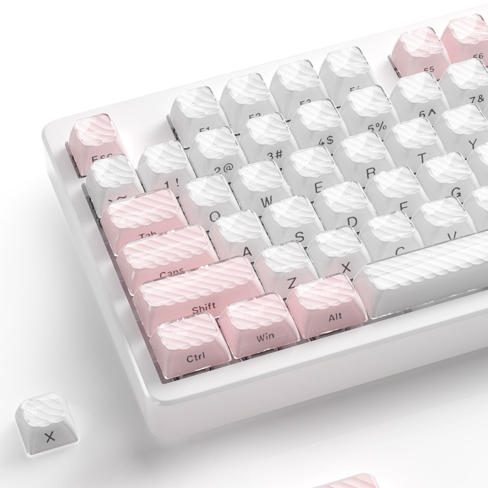 White and pink OEM profile keycap set with sculpted legends on a clear tray