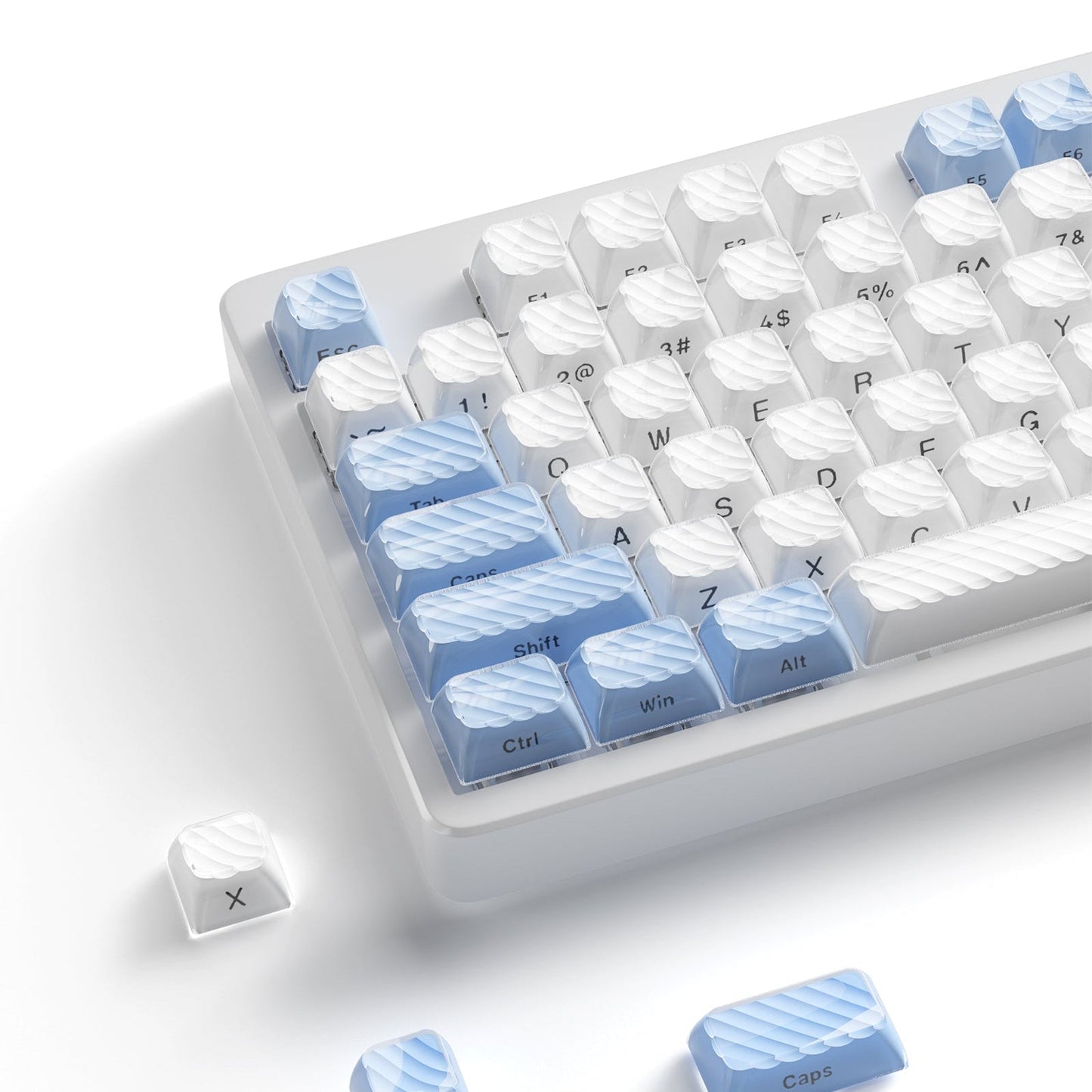 Blue and white OEM profile keycap set with sculpted legends on a clear tray