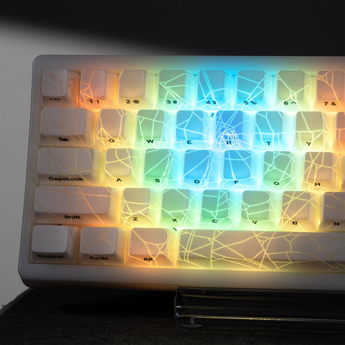 Multicolor RGB backlit keycap set with spider-web shine-through pattern