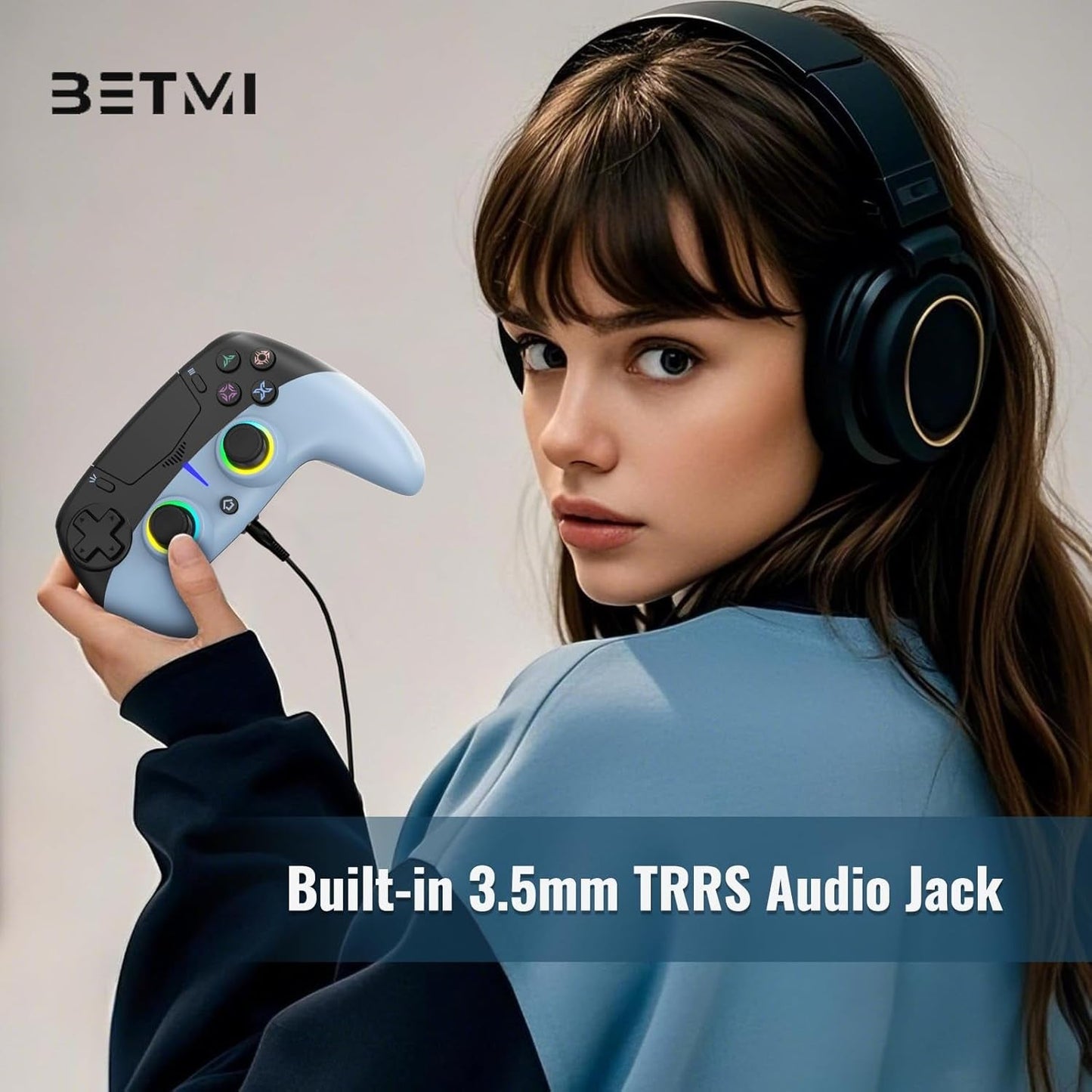 Sky blue wireless game controller with audio jack port, held by a player wearing headset