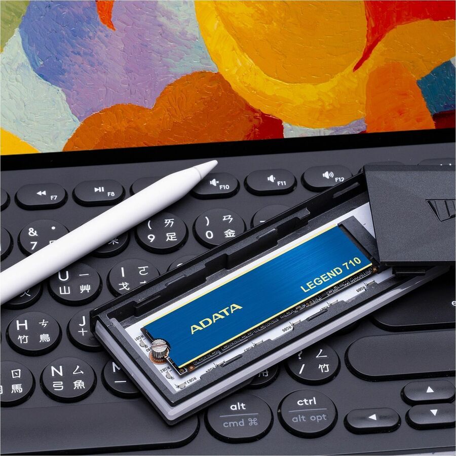 Adata LEGEND 710 NVMe M.2 2280 SSD placed on a keyboard, blue face with text