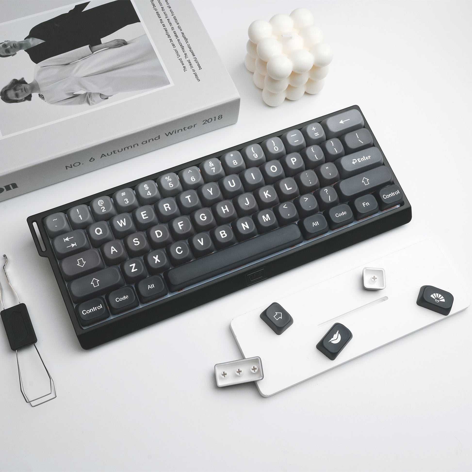 Dark gray PBT keycaps on keyboard, with a few loose replacement keys