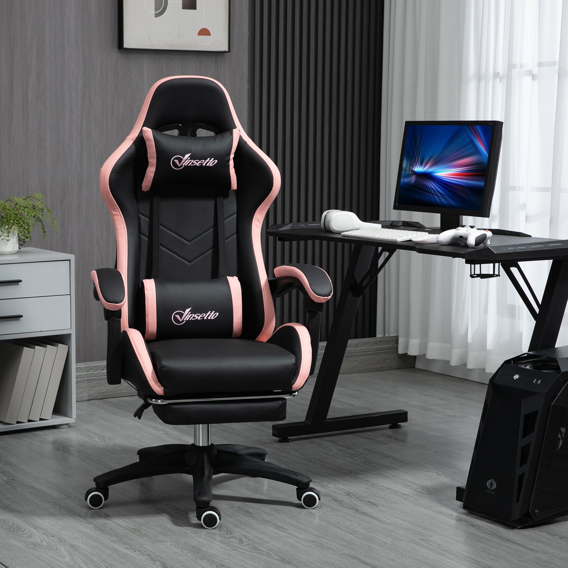 Black and pink PU leather gaming chair with headrest, lumbar support, and caster wheels