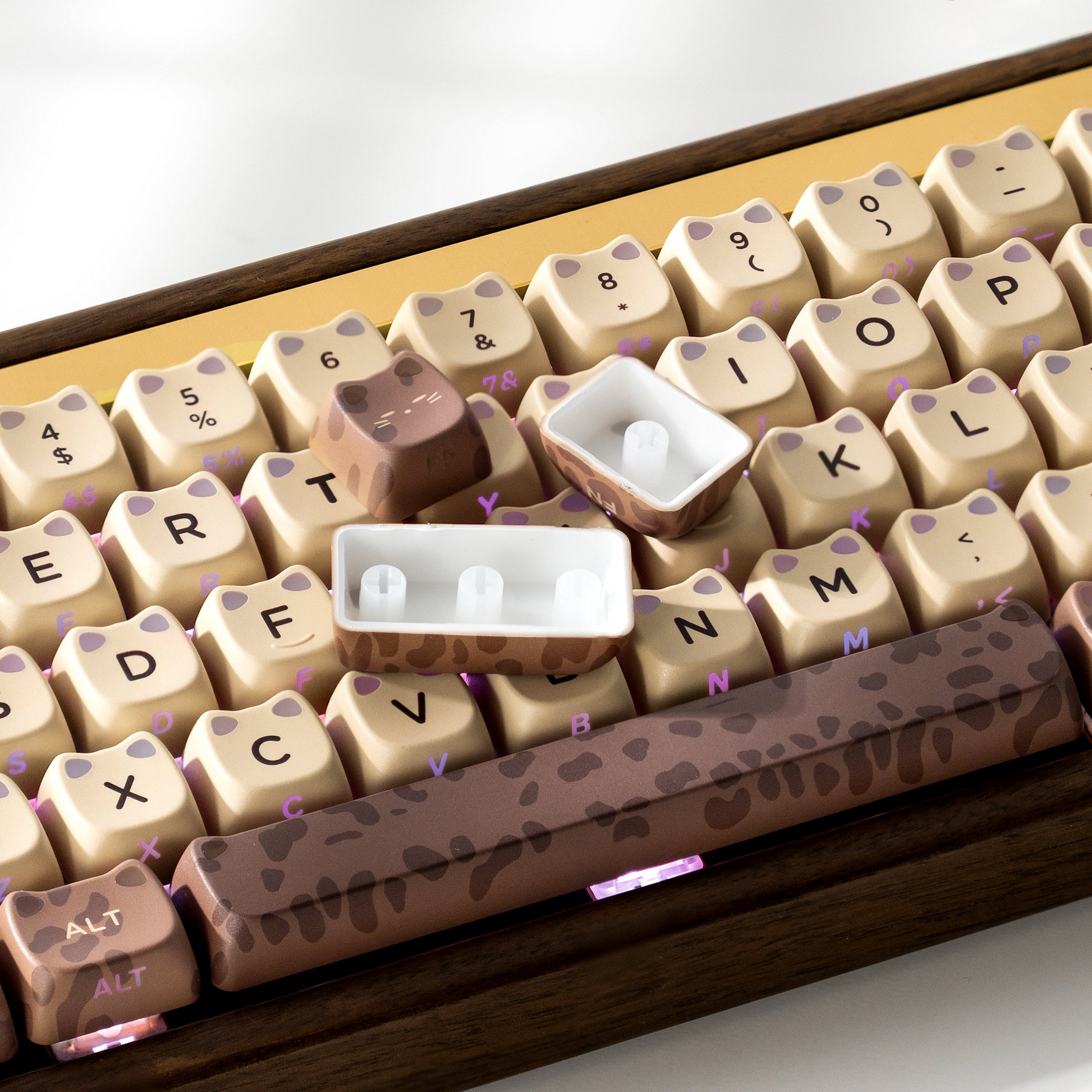 Cream and brown keycap set with leopard-texture accents and subtle purple backlight