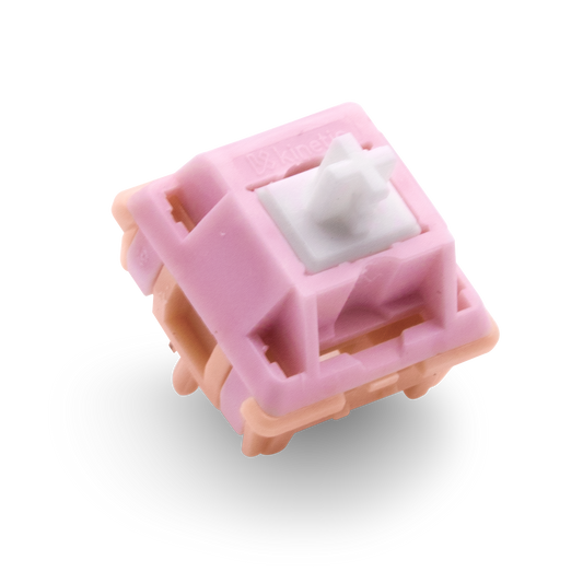 Kinetic tactile switch with pink housing and white cross stem, angled view