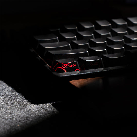 Black keyboard keycap set with glossy shine-through legends and topographic pattern
