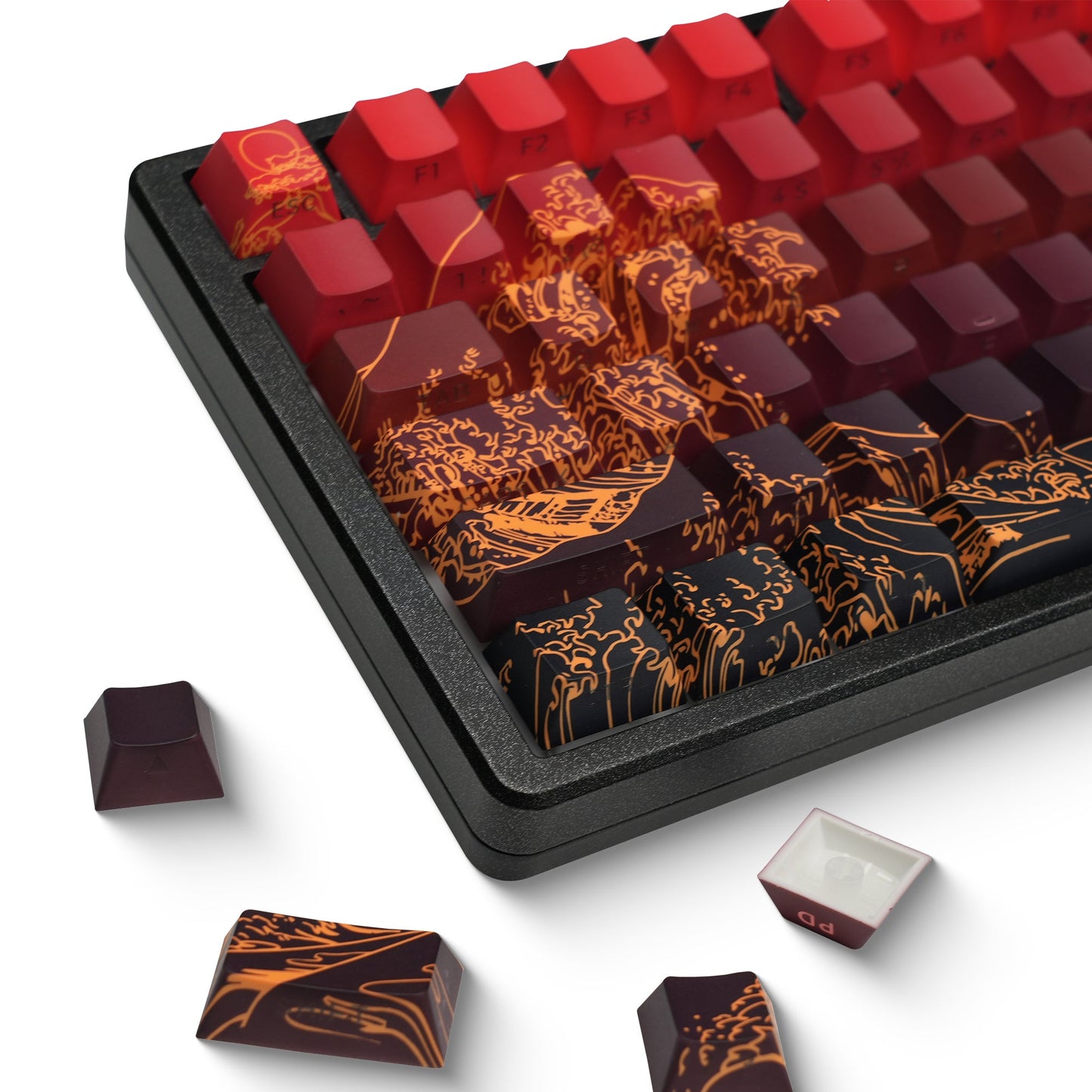 Red PBT keycap set with gold landscape side print in a tray, with loose keys