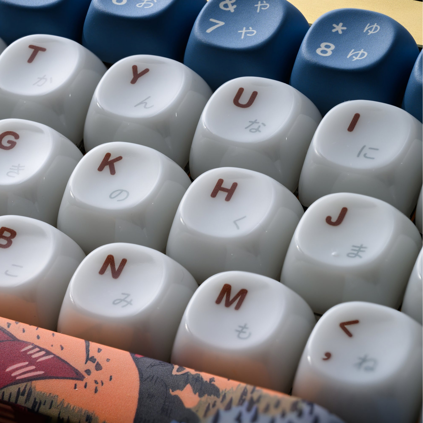 White MOA-profile keycaps with blue accents and red-brown printed symbols