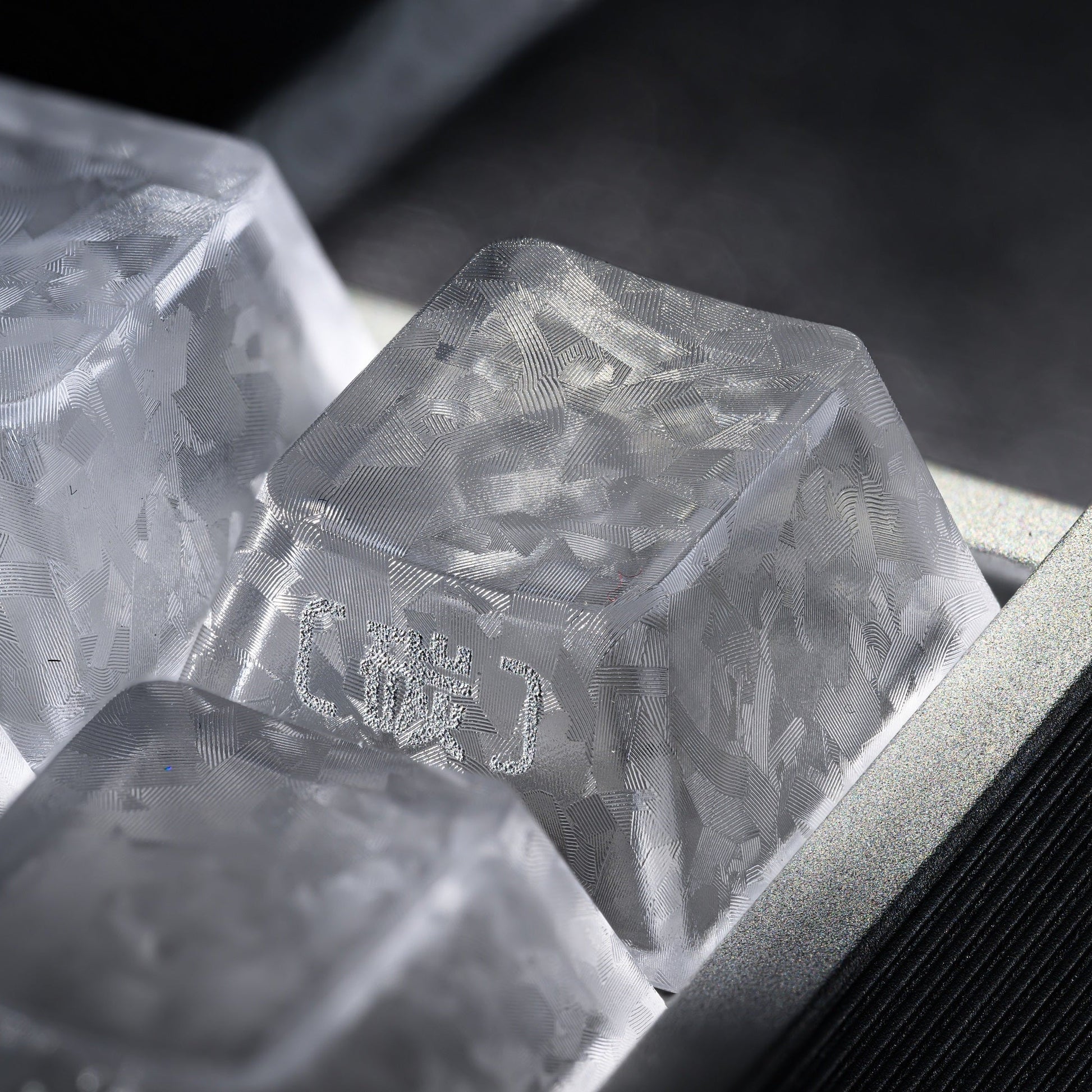 Clear translucent cherry-profile PC keycap close-up showing etched side legends
