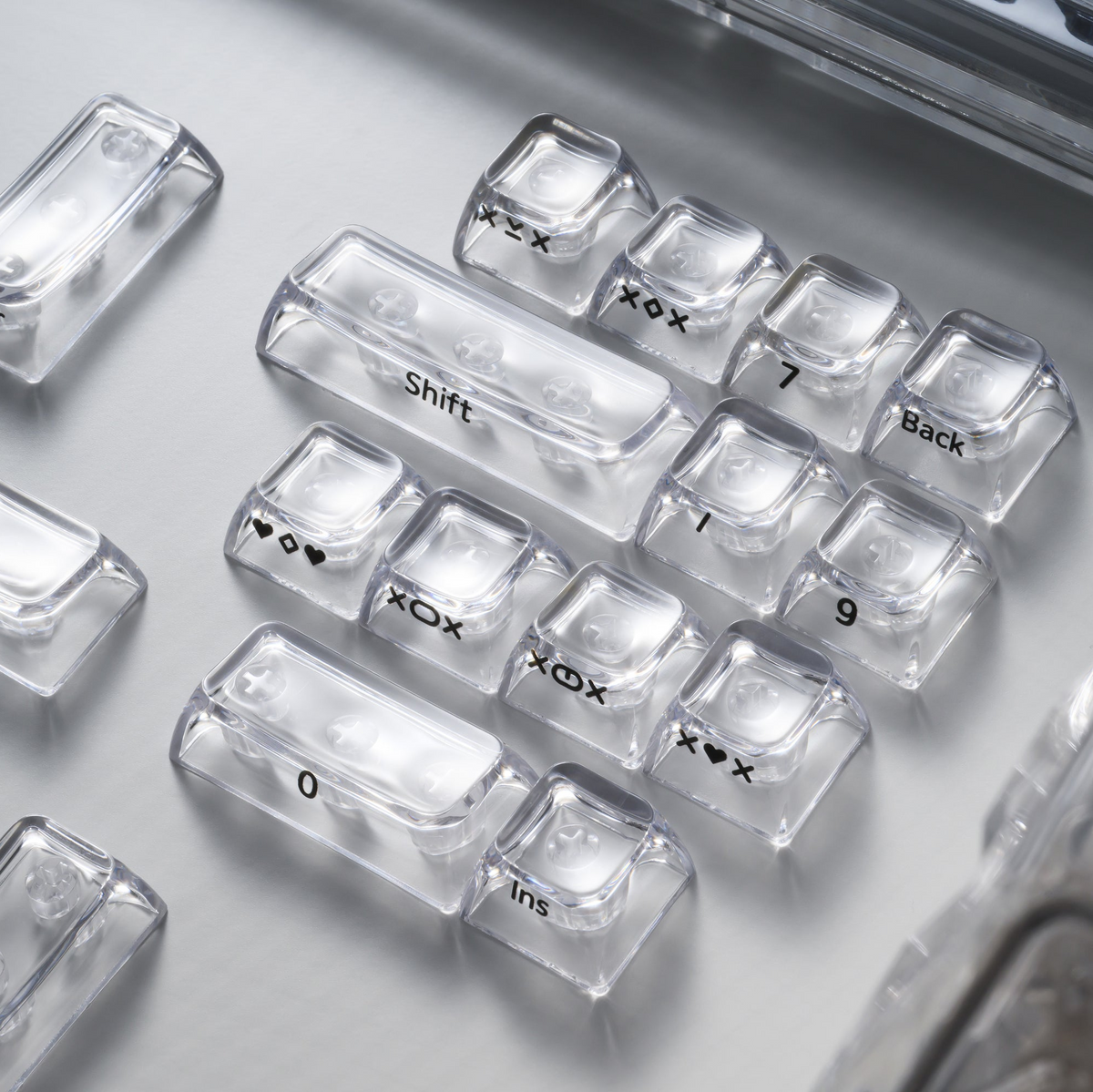 Close-up of clear transparent SA keycaps with “Shift,” “Backspace,” and symbols