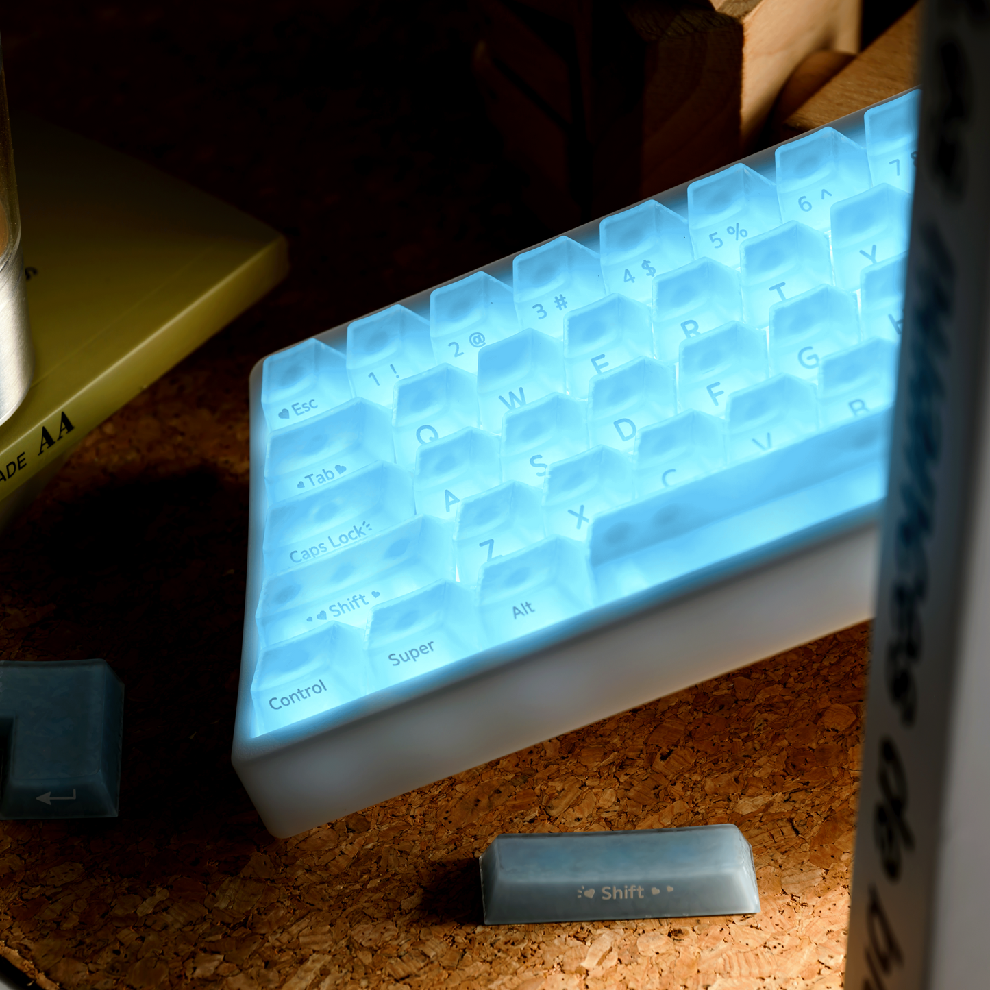 Mechanical keyboard close-up of light blue translucent keycaps with printed legends