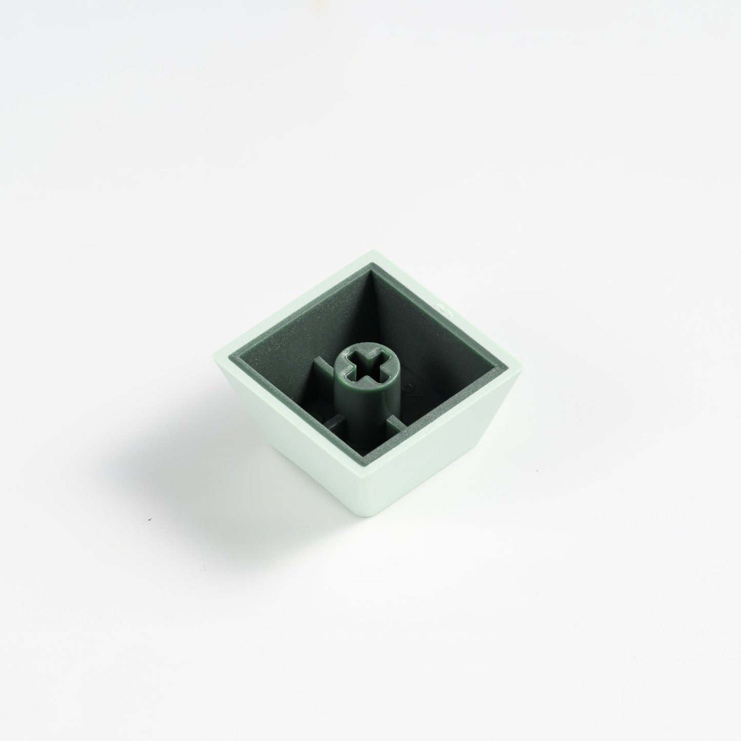 Mint PBT keycap with stem opening visible on the underside