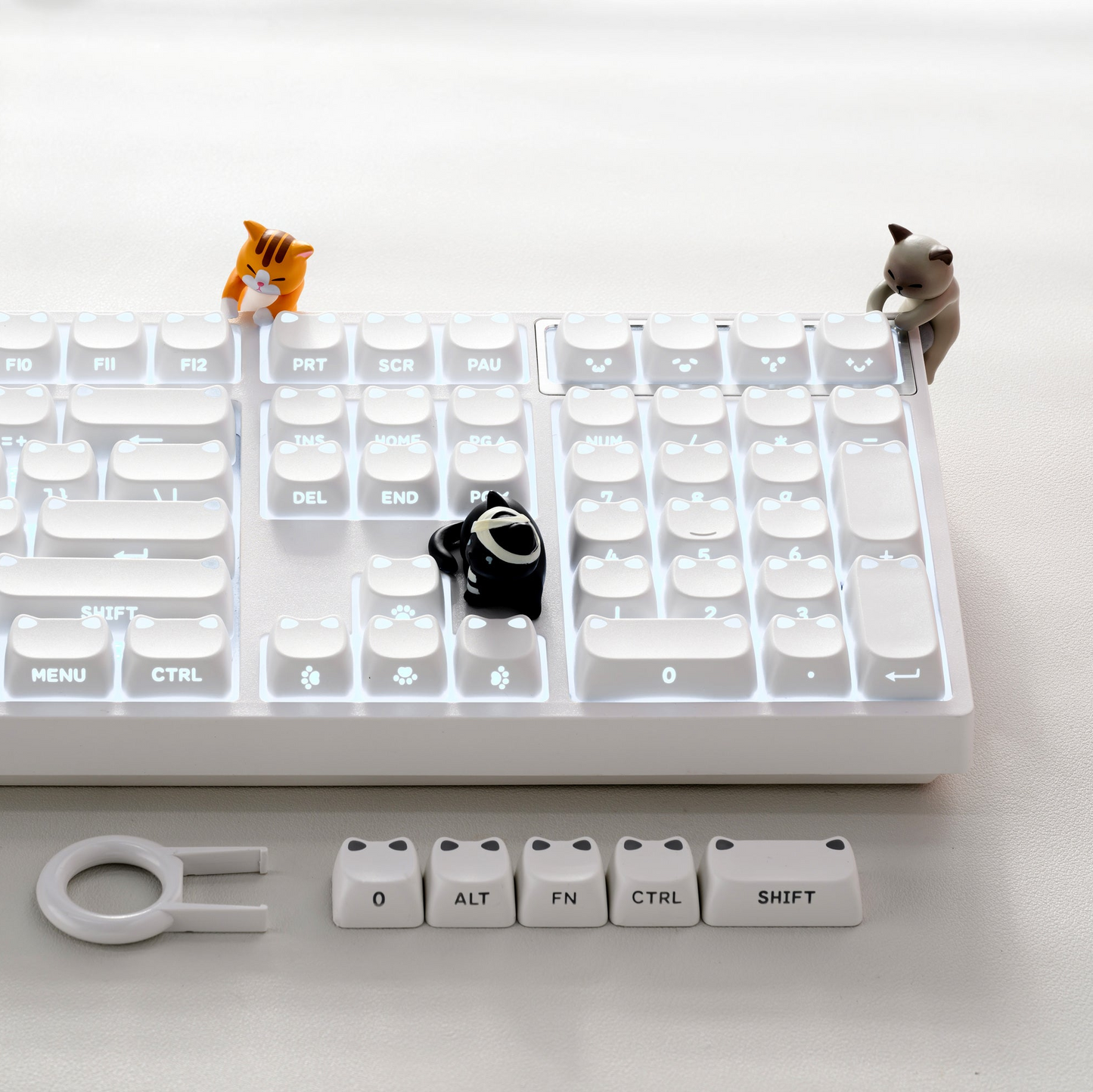 Creamy white keycap set with glow-ready shine-through legends and small accent caps