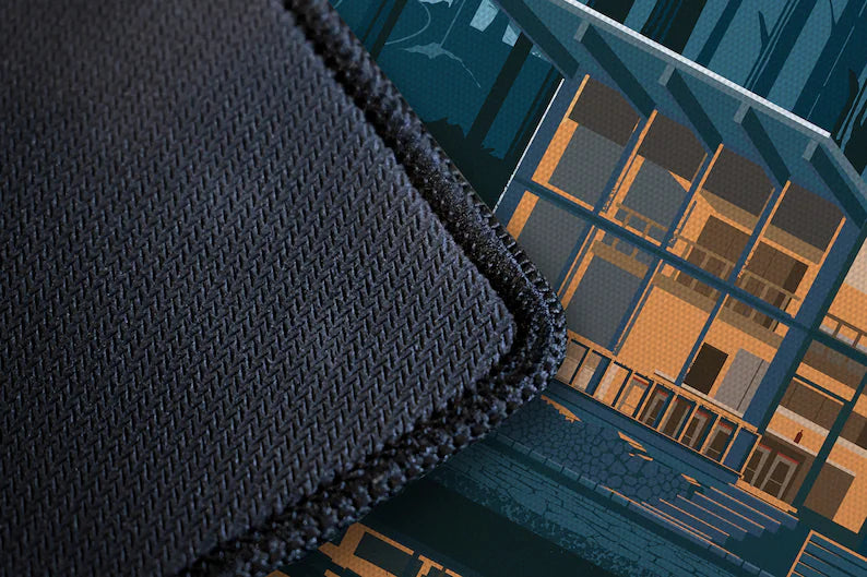Textured dark desk mat edge with woven fabric and cabin mural corner