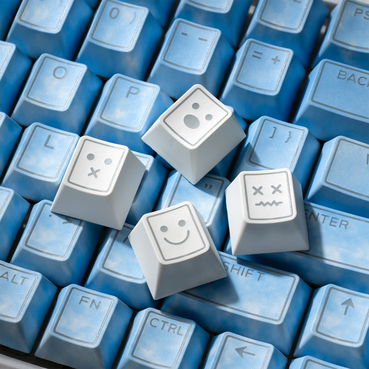 White PBT keycaps with light-blue legends, double-shot icon close-up
