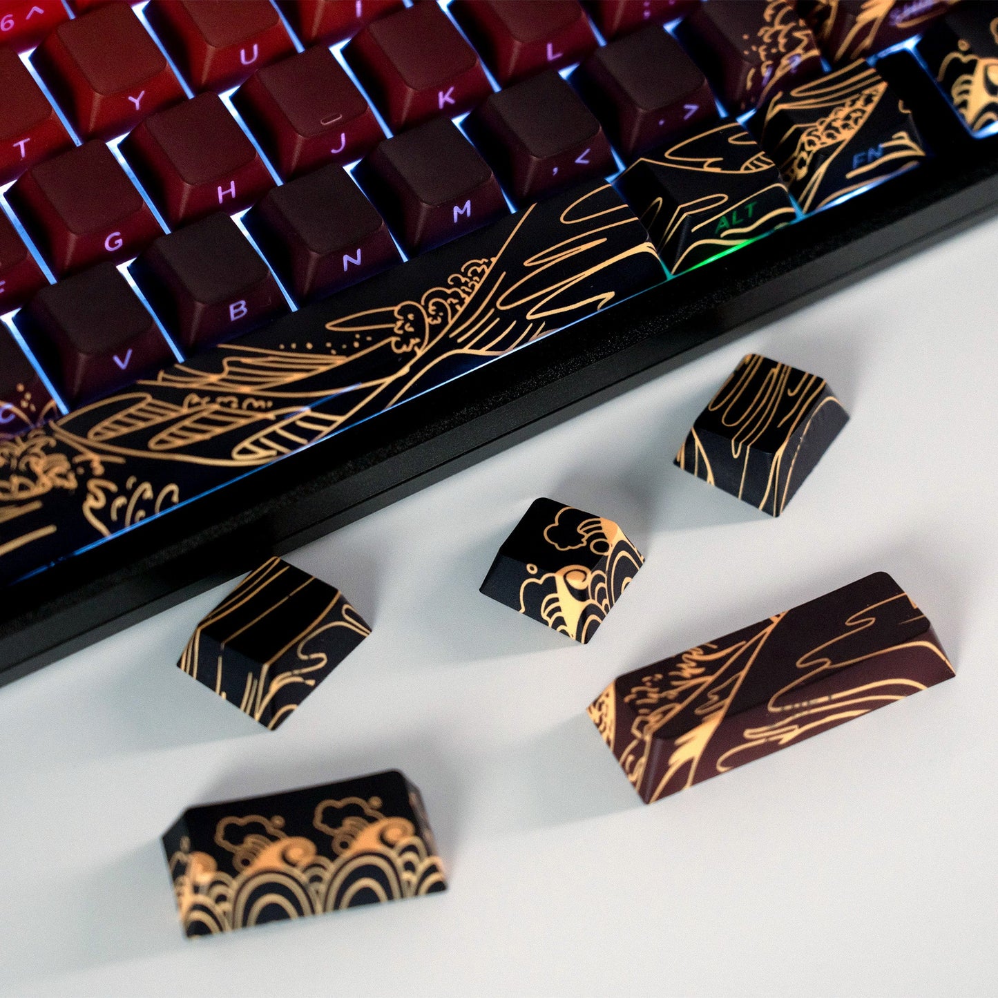 Cherry-profile keycaps with gold wave side print on a white keyboard tray