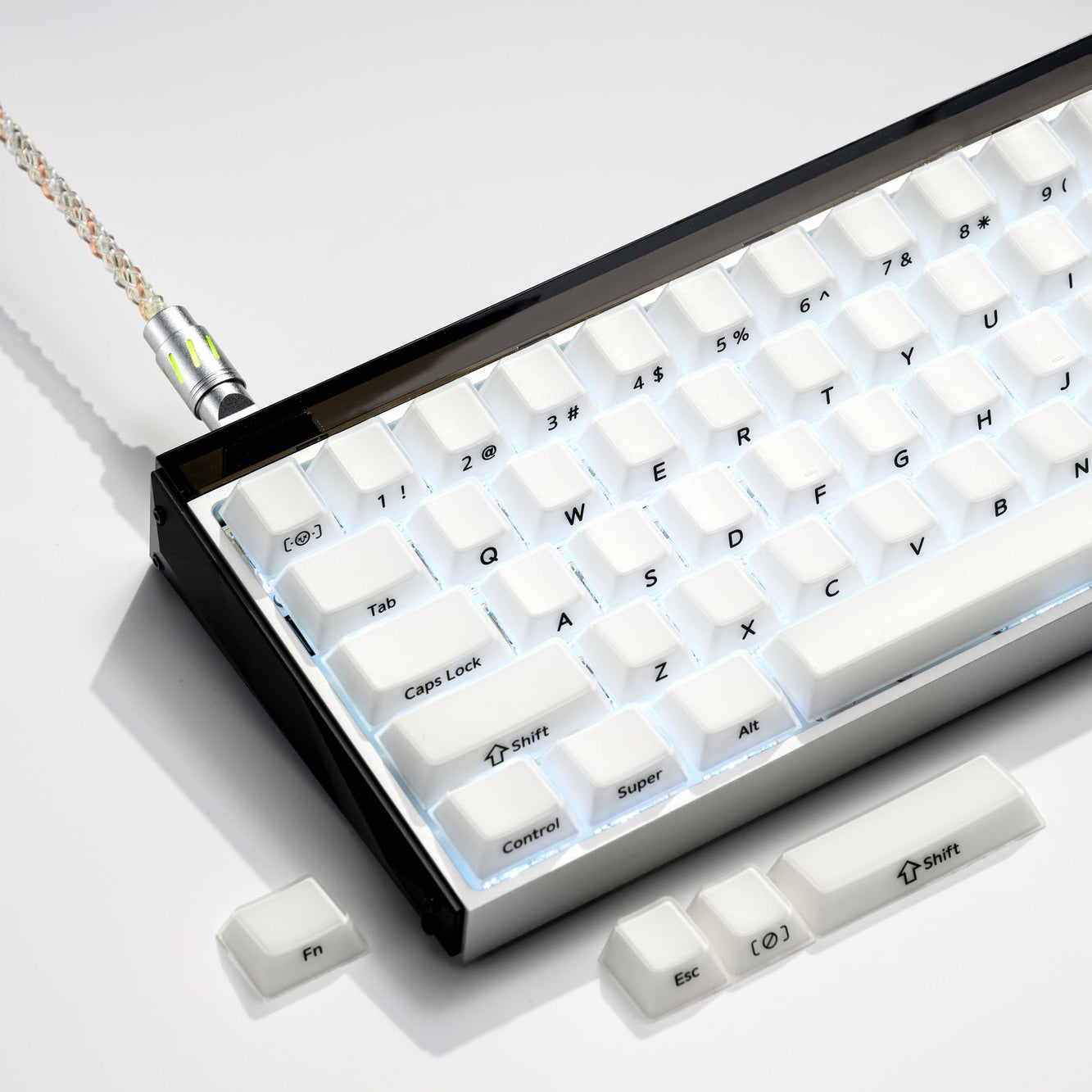 White translucent keycaps with blue legends in a tray, overhead view.