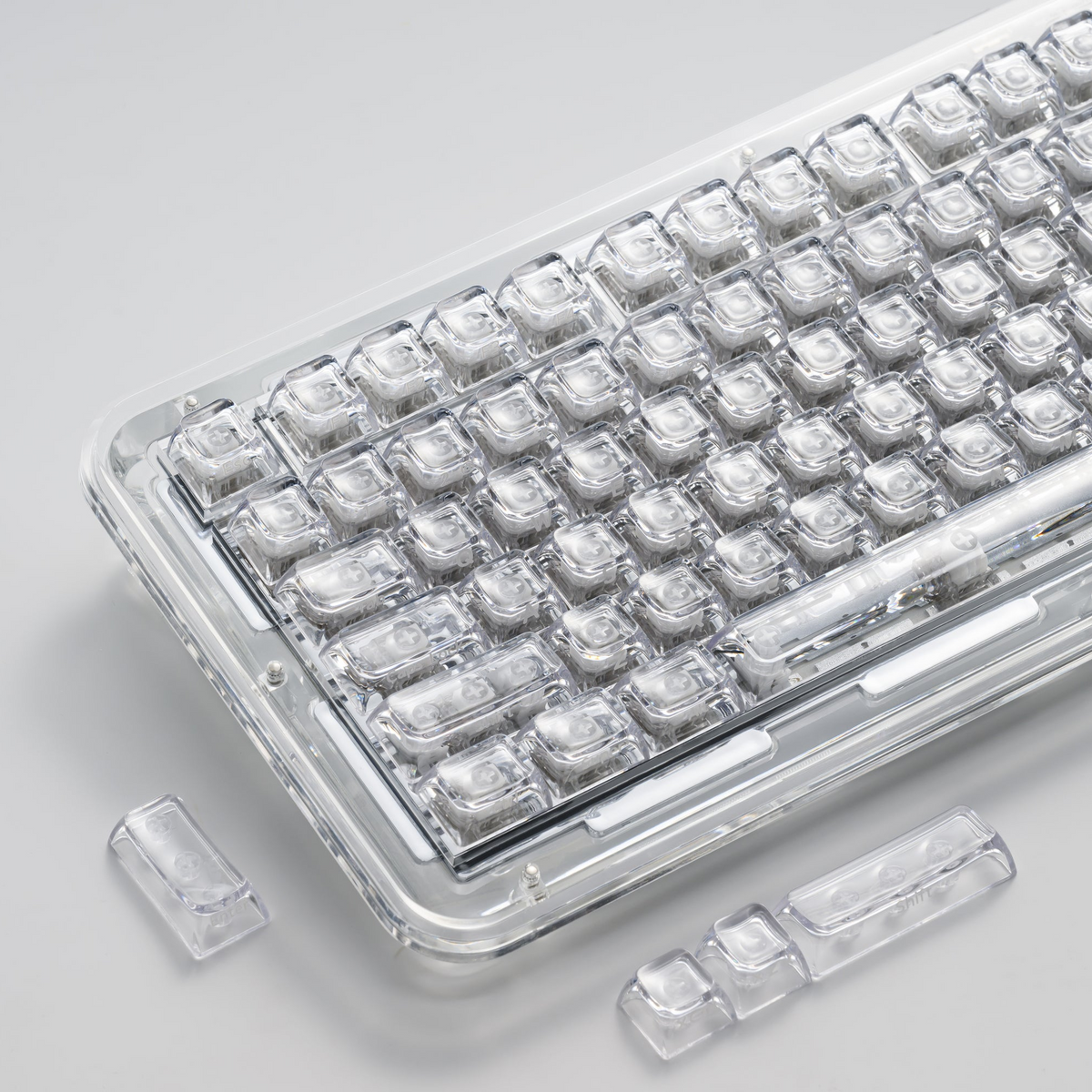 Transparent SA profile keycap set with clear legends, shown in a tray