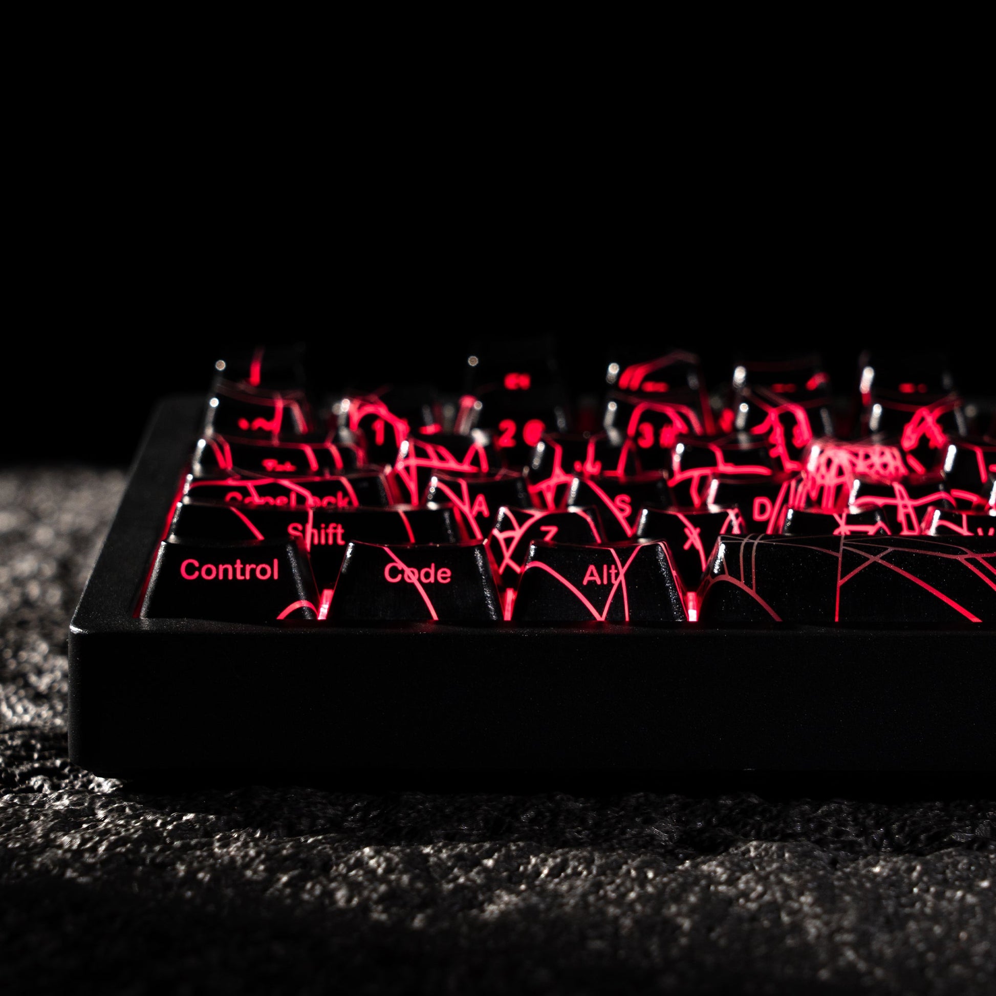 Keycap set with spider-web shine-through pattern, red backlit key legends
