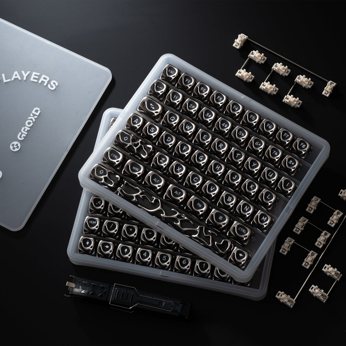 Silver metallic keycap set in plastic box with extra keycaps