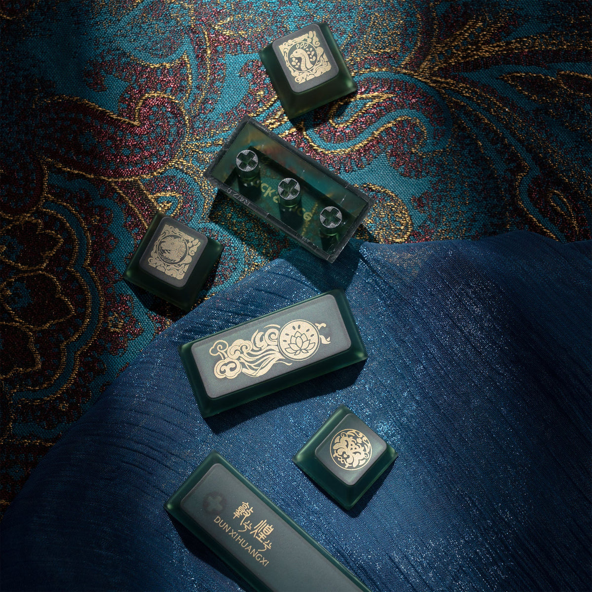 Cherry-profile keycaps with dark green and black keys, featuring ornate emblem prints