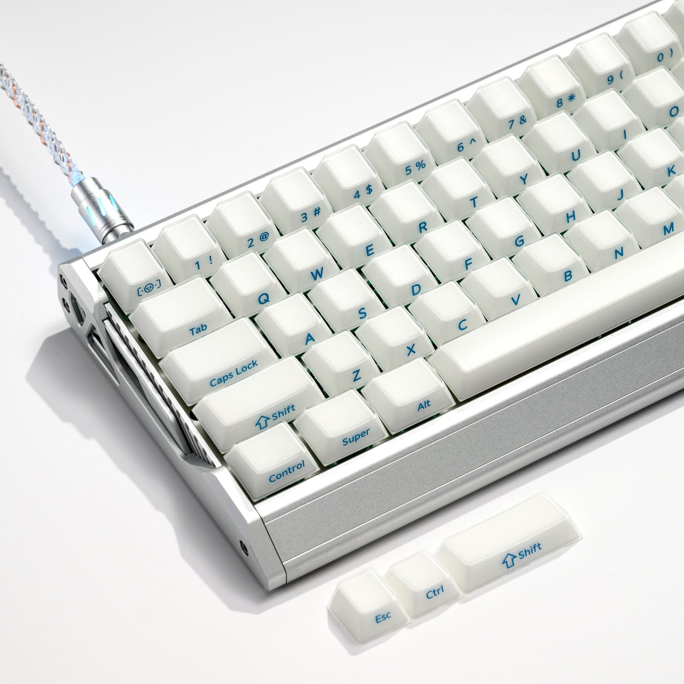 White translucent keycaps with blue legends on a keyboard, tilted overhead angle.