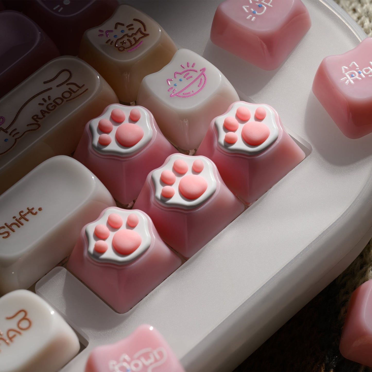 Pink cat-paw keycaps on an acrylic mechanical keyboard, soft translucent finish