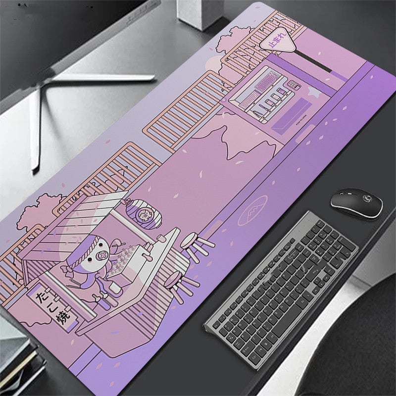 Purple desk mat with cartoon design on a desk with keyboard and octopus.