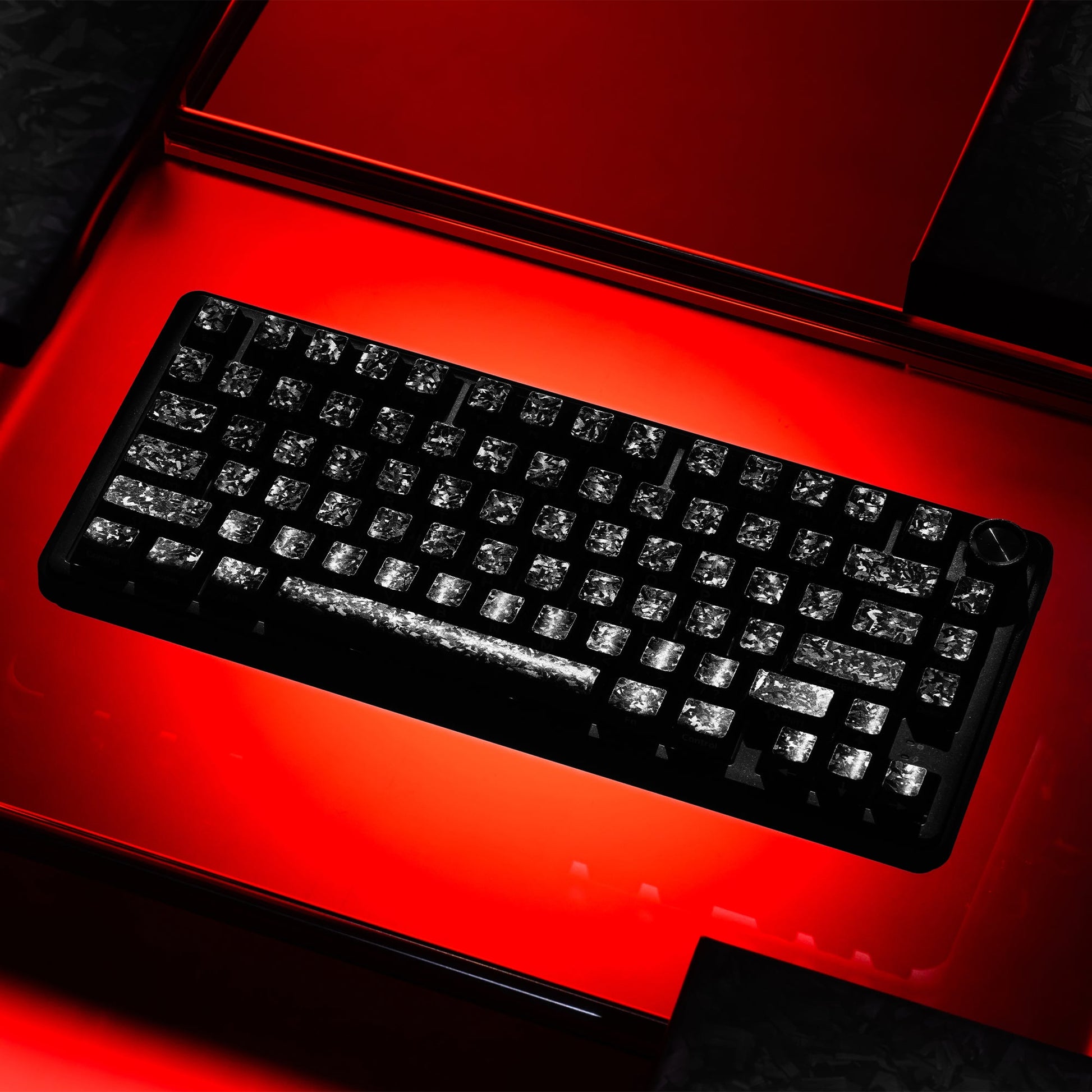 Black forged carbon-look PC keycaps set with side-printed legends on a keyboard
