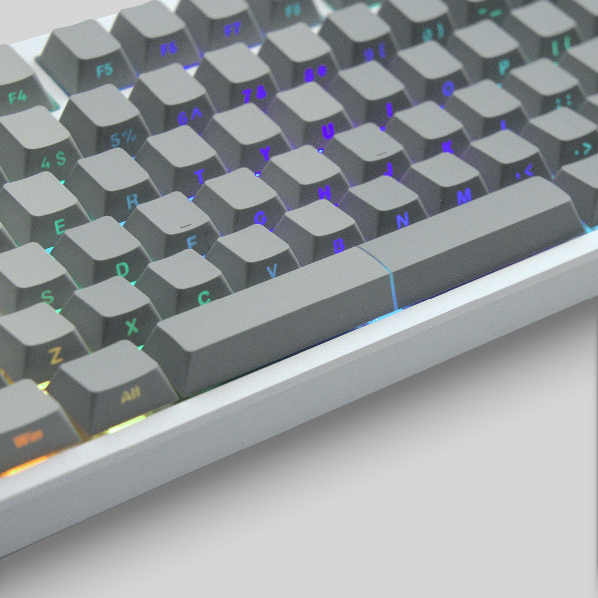 Cherry-profile keycap set close-up, dark gray keys with purple and green legends