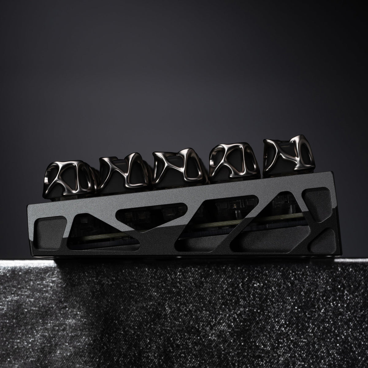 Silver metallic keycaps on a black keyboard plate, close-up row