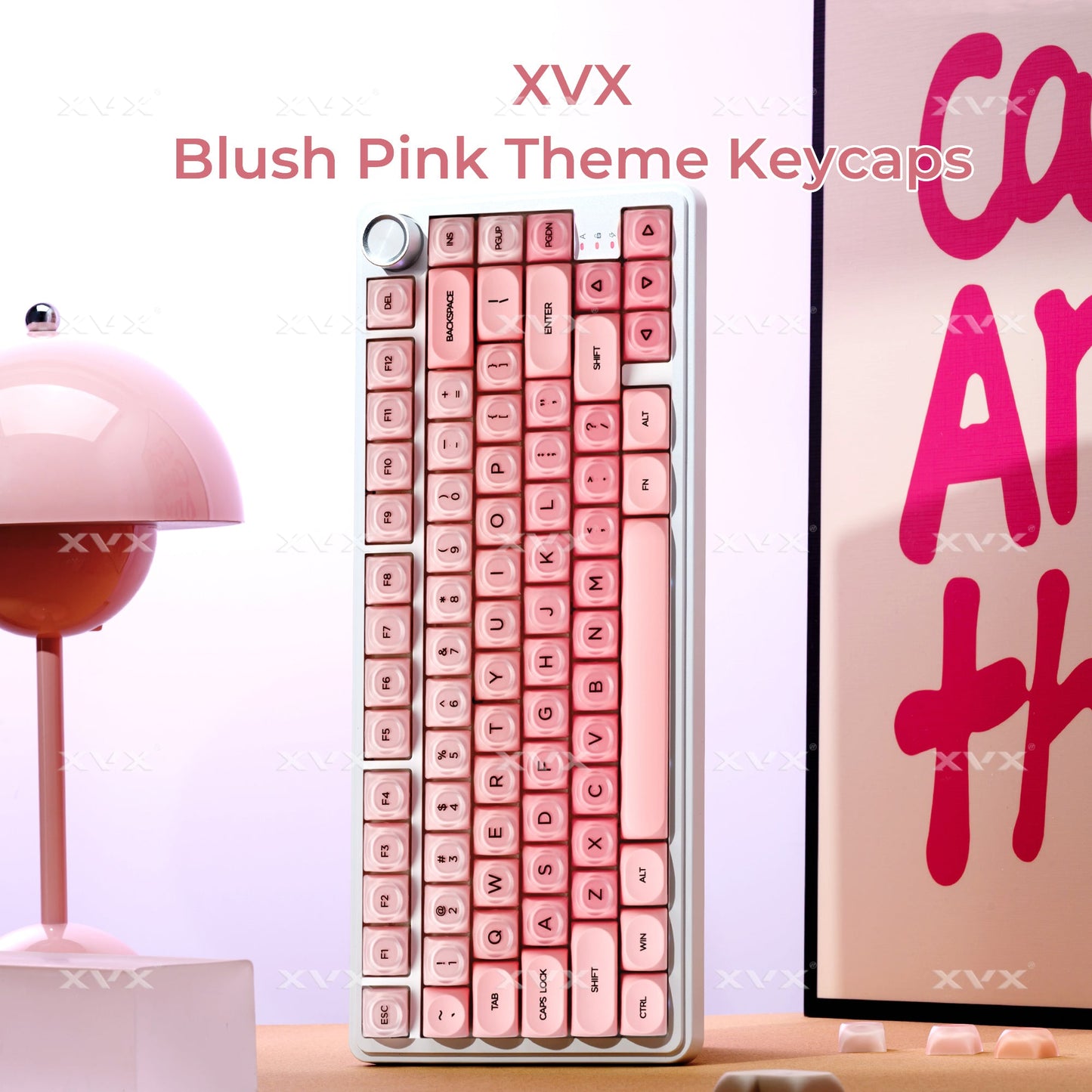 Blush pink-themed keycap set displayed in a clear box with rows of sculpted keys
