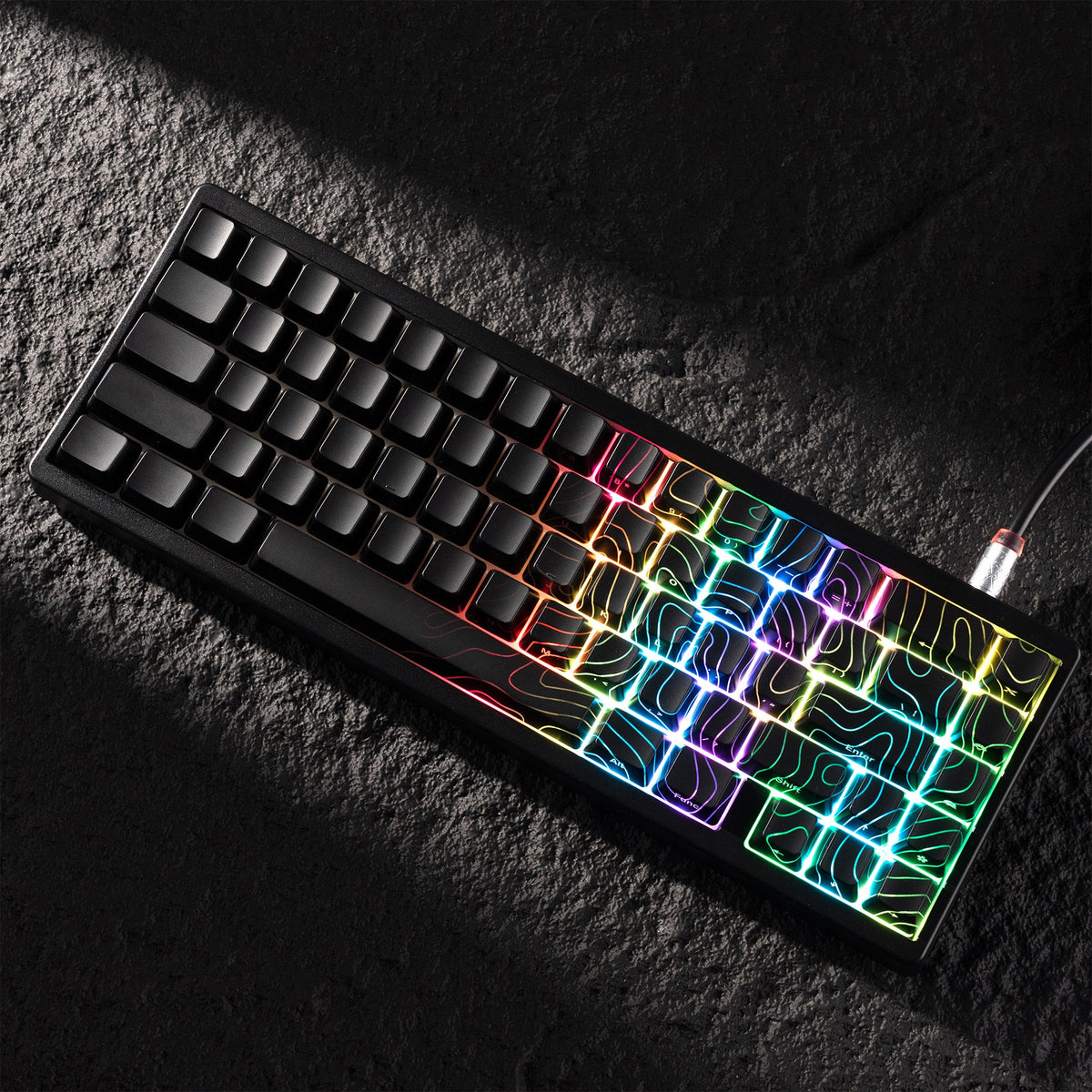 Black keyboard keycaps with neon-lit topographic shine-through glow lines