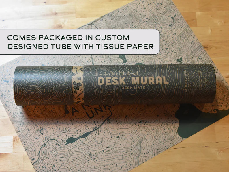 Rolled desk mat tube packaging with printed map and text on top