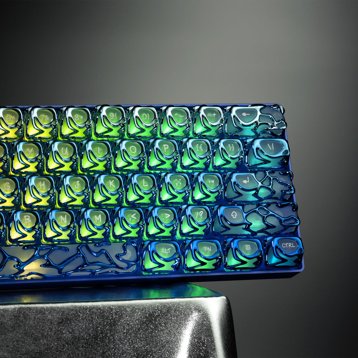 Venom-style liquid metallic keycaps, neon blue-green gradient, full layout on tray