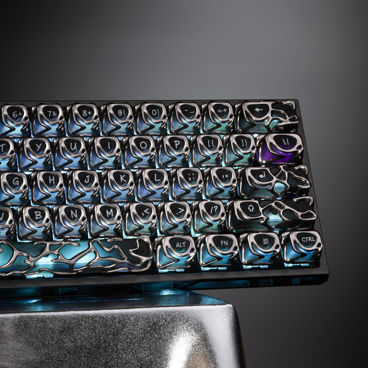 Blue metallic keycap set with engraved legends, installed on keyboard