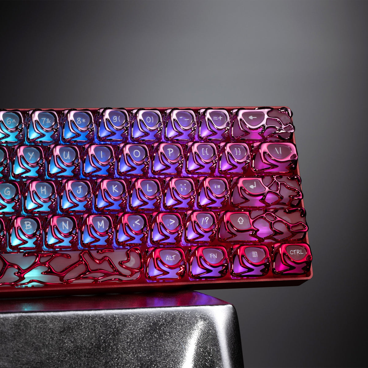 Venom-style liquid metallic keycaps, blue and pink, full keyboard layout on tray
