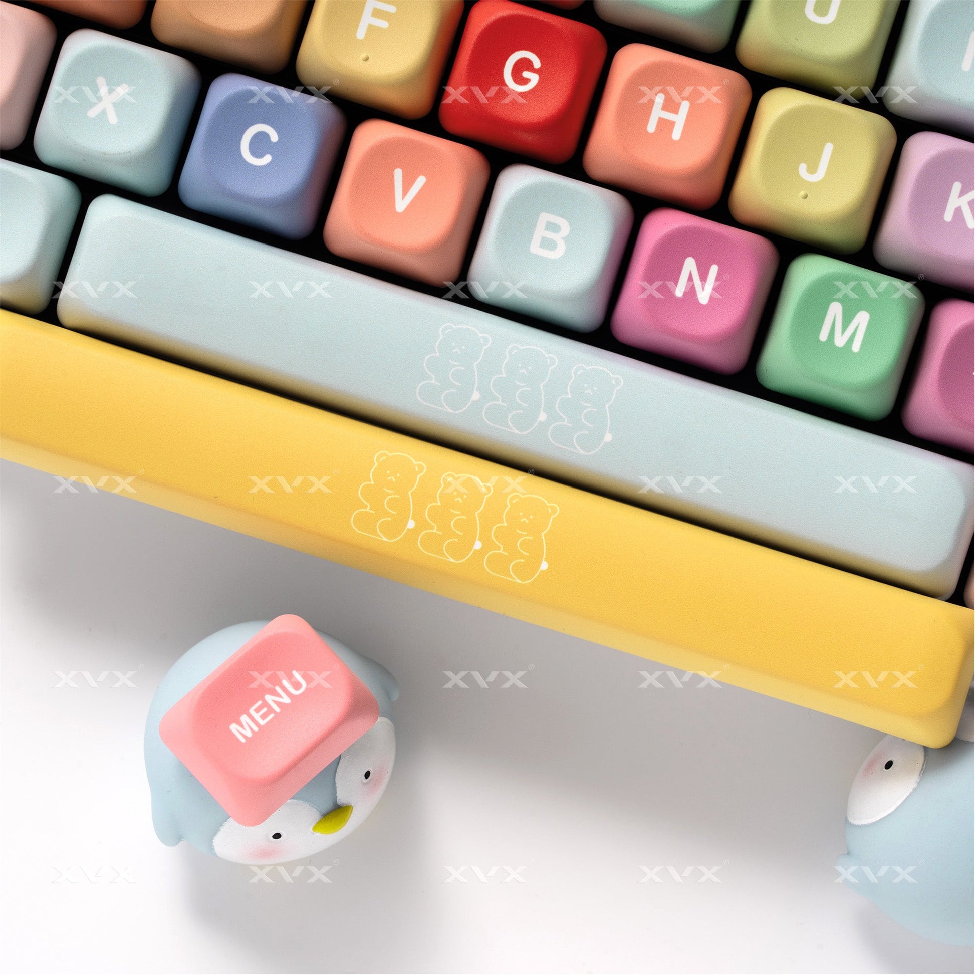 Close-up pastel keyboard keycaps with decorative spacebar and curved legends