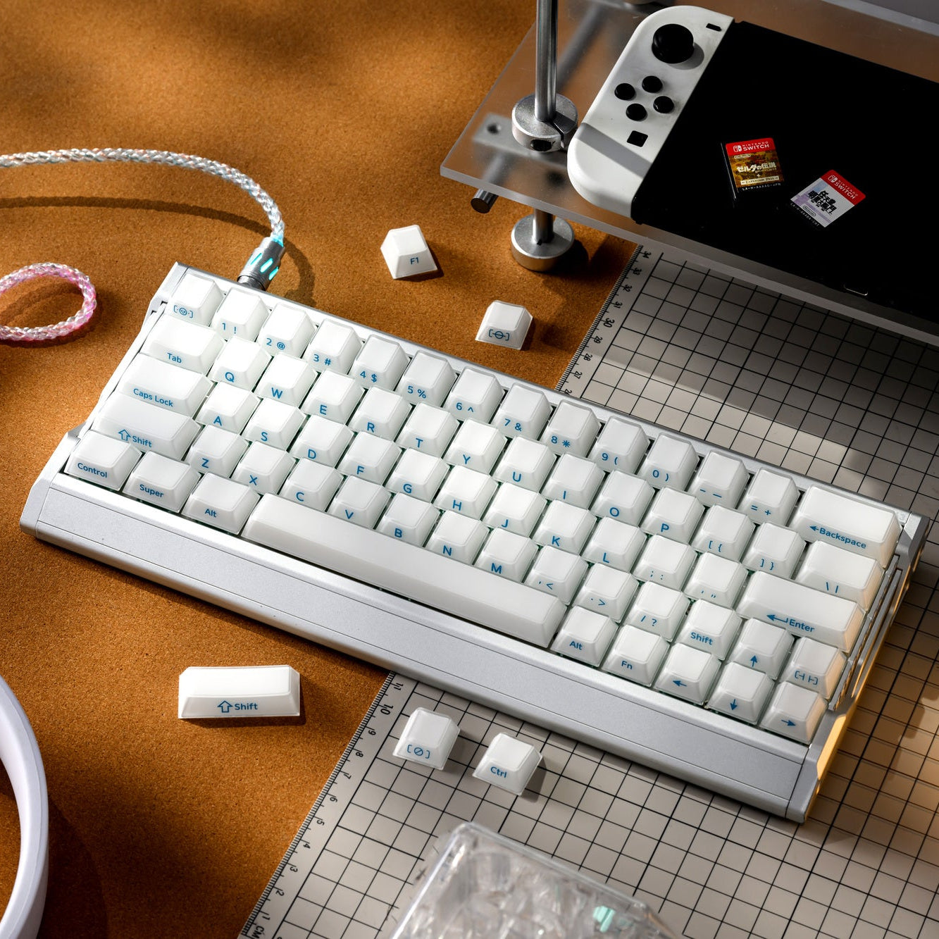 White translucent keycap set with blue legends on a keyboard and loose caps nearby.